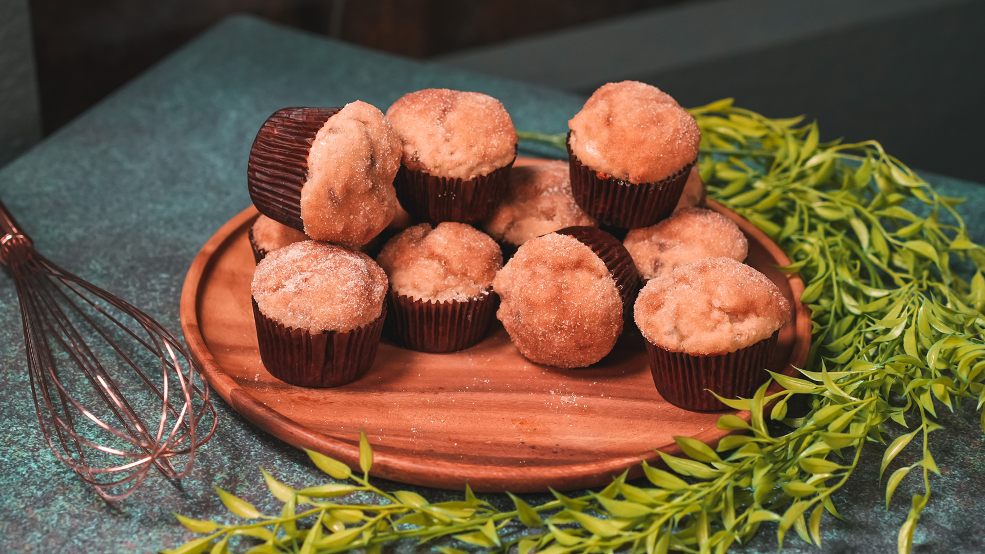 Dove's buttered muffins on a plate next to a whisk