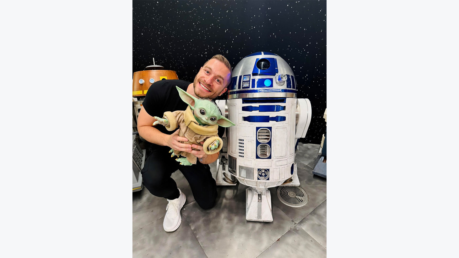 Senior animator Greg Verreault poses with Grogu and R2-D2 at Lucasfilm headquarters.