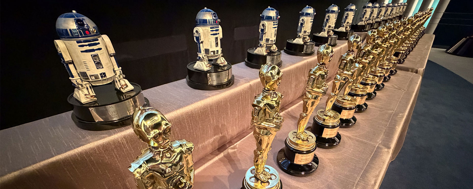 A line-up of Lucasfilm Service Awards trophies, including ones of R2-D2 and C-3PO.